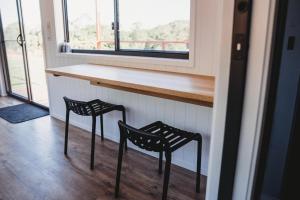 two chairs sitting at a counter in a room with a window at High Valley Dawn Permaculture Farm in Yeppoon +34 photos