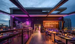 a view of a restaurant with tables and chairs at Sindhorn Midtown Hotel Bangkok, Vignette Collection by IHG in Bangkok