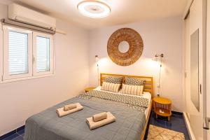 a bedroom with two beds and a mirror on the wall at Oceanfront Oasis By Dream Homes Tenerife in Acantilado de los Gigantes