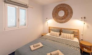 a bedroom with a bed and a mirror on the wall at Oceanfront Oasis By Dream Homes Tenerife in Acantilado de los Gigantes