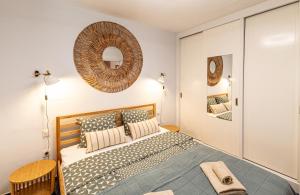 a bedroom with a bed and a mirror on the wall at Oceanfront Oasis By Dream Homes Tenerife in Acantilado de los Gigantes +40 photos