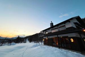 a building in the snow on a snow covered slope at Shiki at Tangram in Madarao Kogen
