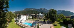 a resort with a pool and mountains in the background at Hartweger's Hotel in Haus im Ennstal