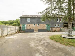 a large house with a fence in front of it at Bluebell Cottage in Leominster