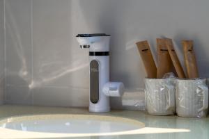 a kitchen counter with a juicer and some wooden sticks at Kaibu Courtyard Superior Apartment, Changjiang Cable Car Nanbin Road, Chongqing in Chongqing +37 photos