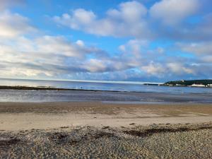 a beach with the ocean in the background at At Caledonia in Douglas