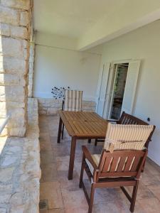 a wooden table and two chairs on a patio at Margaret 150 METERS TO THE BEACH in Banjole +9 photos