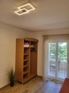 a room with a book shelf and a window at Margaret 150 METERS TO THE BEACH in Banjole
