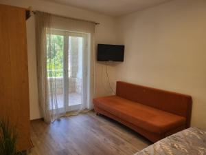 a living room with a couch and a window at Margaret 150 METERS TO THE BEACH in Banjole