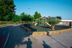 a shadow of a person taking a picture of a playground at Apartma Edra - Žusterna in Koper