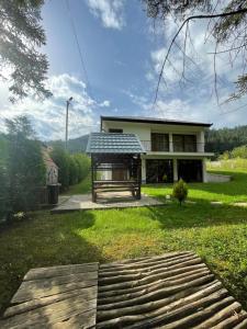 a house with a solarium in the yard at Villa Bella Una - Prizemlje in Cazin