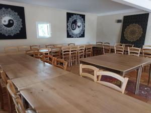 a room with wooden tables and chairs in it at Escale de la Jurade in Rogues +96 photos