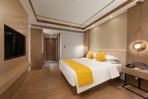 Poltton International Hotel - Chaozhou Hanjiang客房内的一张或多张床位