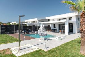 a villa with a swimming pool and a resort at MySarti Villas in Sarti
