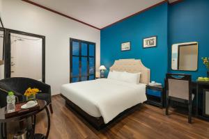 Postel nebo postele na pokoji v ubytování Hanoi Starlight Boutique Hotel + 37 fotografií