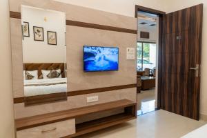 a living room with a tv on a wall at Green Galaxy Villa in Amritsar