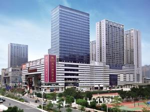 a large building in a city with tall buildings at Pearl River International Hotel - Canmetro line 11 YiJing Lu station in Guangzhou