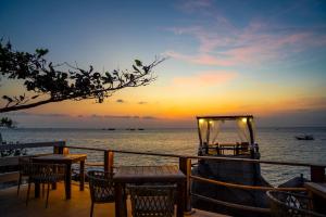 a wedding reception on the beach at sunset at Dusit Buncha Koh Tao by Riya Group in Ko Tao