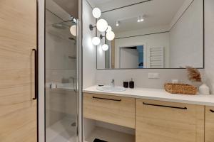 a bathroom with a sink and a mirror at GRANO FLATS Trimare Sztutowo in Sztutowo +120 photos
