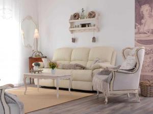a living room with a white couch and a table at Nausikaa's- Fleur de Lis in Groß Schwansee