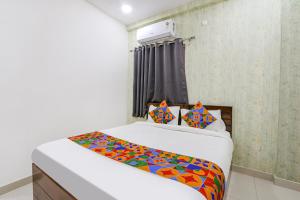 Dormitorio pequeño con cama con sábanas coloridas en Via Dream Connect - Nr Narsingi, en Hyderabad