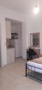 a room with a kitchen and a bed in it at Lady S Holiday Studio in Lampi