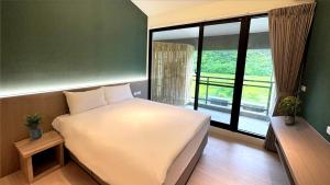 Ένα ή περισσότερα κρεβάτια σε δωμάτιο στο Longtan Lake Inn +13 φωτογραφίες