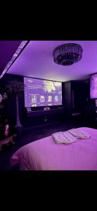 a bedroom with a bed and a projection screen at Love Room Secret-private jacuzzi spa & cinéma Bucuresti in Voluntari +23 photos