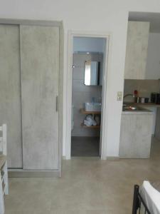 a kitchen with a sliding door in a room at Lady S Holiday Studio in Lampi