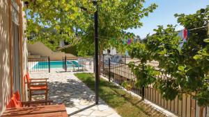 a fence with two chairs next to a pool at Armonia Nakas in Yenion
