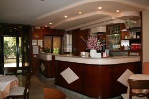 a bar in a restaurant with a table and chairs at Hotel Rocco in Carugate