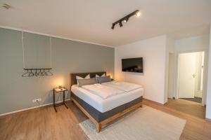a bedroom with a large bed in a room at RR - Studio Apartment 38 qm - Parking - Washer in Magdeburg