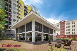 a building with windows and chairs in front of buildings at Condotel in Pasig City - Hampton Gardens in Manila