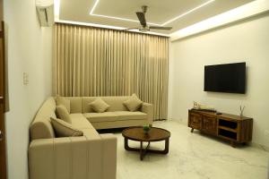 a living room with a couch and a tv at Cosy Cottage in Chandīgarh
