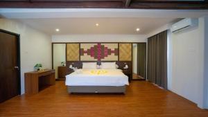 a bedroom with a large white bed in a room at Luxury Samoya villa in Jimbaran +21 photos