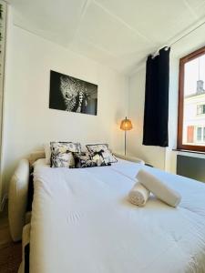 a large white bed in a room with a window at Le République 2, Gare, Centre-Ville in Bourgoin
