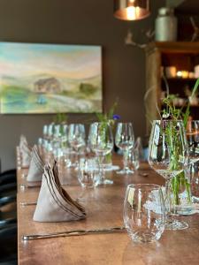 a long wooden table with wine glasses on it at Bjørnfjell Mountain Lodge in Alta