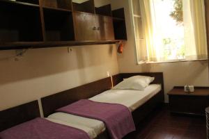 two beds in a small room with a window at Terrazza House Old Town Herceg Novi in Herceg-Novi