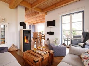 a living room with a wood burning stove in it at Smutje, Ferienhaus in Groß Schwansee