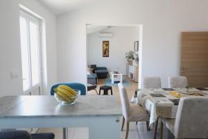 a kitchen and living room with a table and chairs at Surf & joy - Croatia vacation rentals seaview apartment in Okrug Gornji