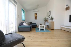 a living room with a couch and a table at Surf & joy - Croatia vacation rentals seaview apartment in Okrug Gornji