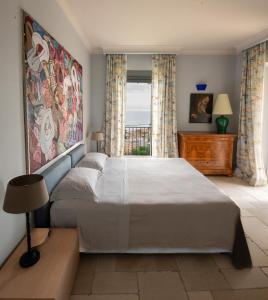 a bedroom with a large bed and a window at Casa Pazzi Dimora d'Epoca in Grottammare