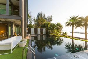 an external view of a house with a swimming pool at @T Boutique Hotel in Klong Wan