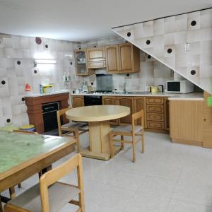 a kitchen with a table and a table and chairs at La Guest House di Trisin in SantʼArcangelo +13 photos