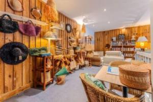a room with wooden walls and tables and chairs at Hôtel Le Grain de Sable in Arès