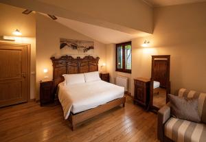 a bedroom with a large bed and a couch at Agriturismo La Cerra in Tivoli