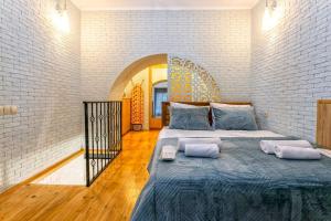 a bedroom with a bed with two pillows on it at Condo in center Tbilisi with Terrace in Tbilisi City +64 photos