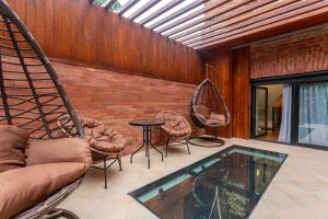 a living room with a couch and chairs and a table at Condo in center Tbilisi with Terrace in Tbilisi City