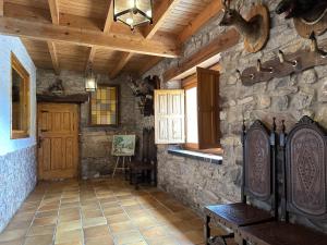 a room with a stone wall and a wooden door at Casa rural C de Caballo, Valdorria Brother Law SL in Valdorria +38 photos