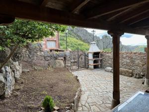 a stone building with a gate and a stone wall at Casa rural C de Caballo, Valdorria Brother Law SL in Valdorria